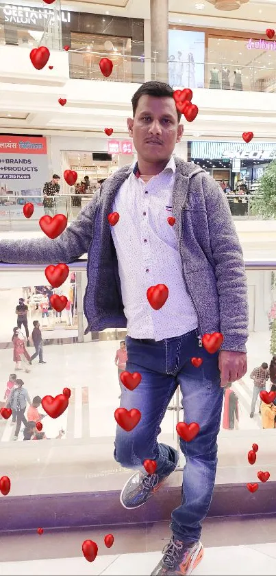 Person standing in a busy shopping mall environment.