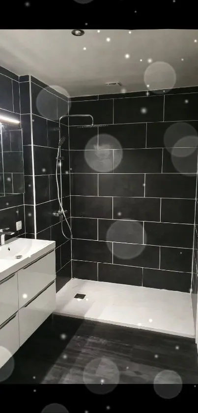 Sleek modern bathroom with black tiles and walk-in shower.