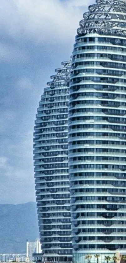 Modern skyscrapers by the ocean under a clear blue sky.