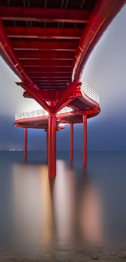 Red bridge at dusk with calm water reflections.