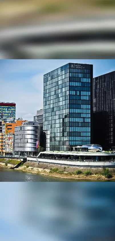 Modern skyscrapers along a serene riverbank with clear blue skies.