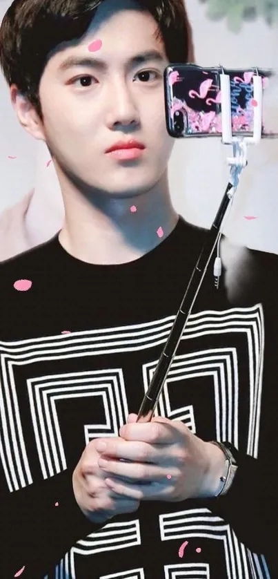 Young man taking a selfie with a stylish background and pink petals.