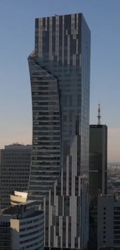 Aerial view of a modern skyscraper against a clear blue sky.