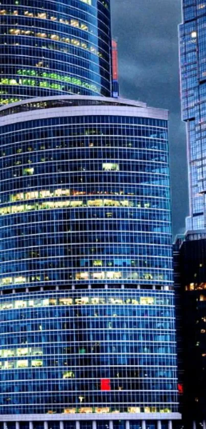 Skyscrapers at night with illuminated windows in an urban cityscape.