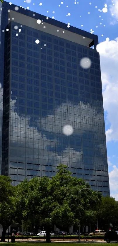 Skyscraper with clouds and trees in urban park.