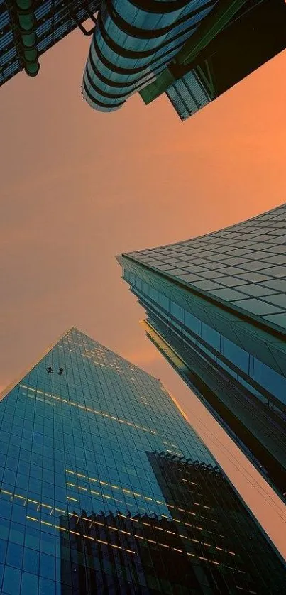 Skyscrapers silhouetted against a vibrant orange sunset.