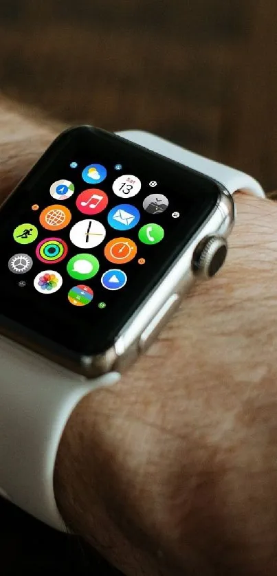 Smartwatch with app icons on wrist.