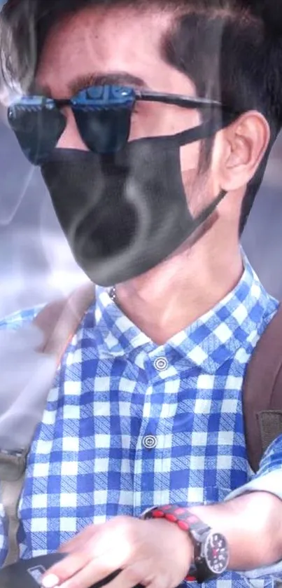 Man with sunglasses and black mask in blue checkered shirt