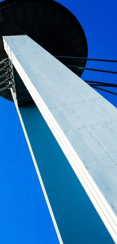 Modern tower against a vivid blue sky.
