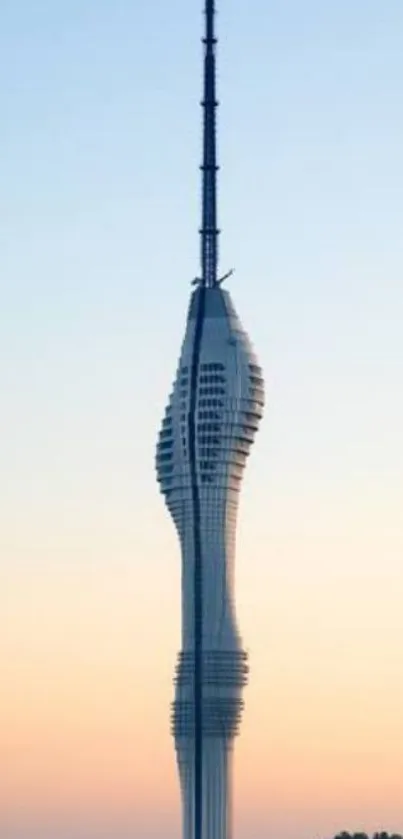 Modern tower silhouetted against a sunset sky.