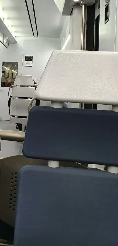 Modern train interior with blue and white seats.