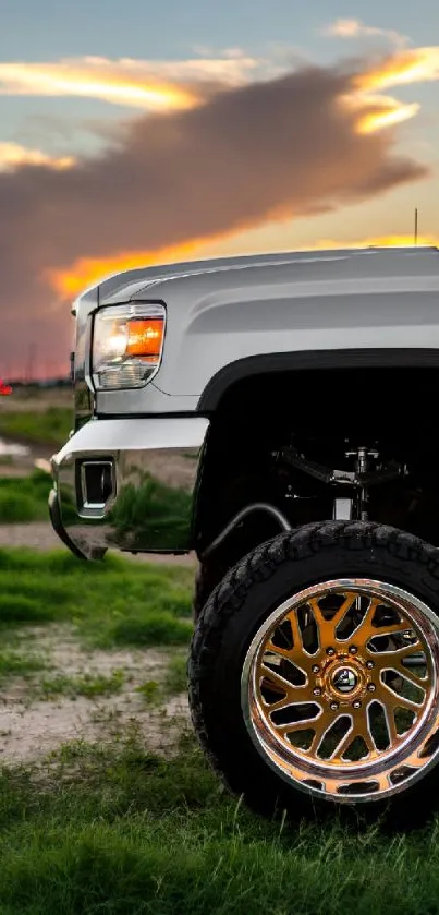 Truck with golden wheels at sunset on a grassy field.