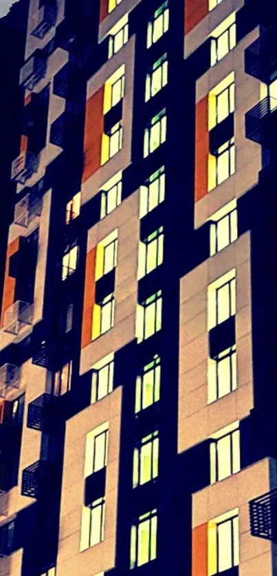 Night view of modern building with geometric design and lit windows.