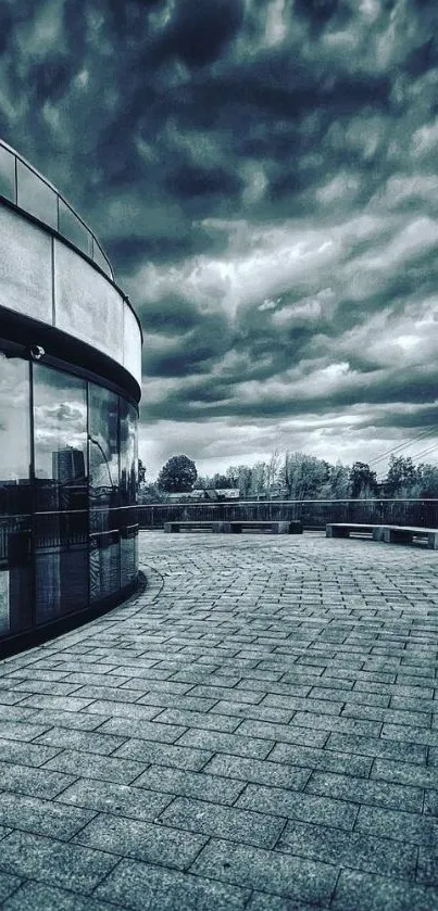 Modern urban architecture with dramatic clouds in grayscale.