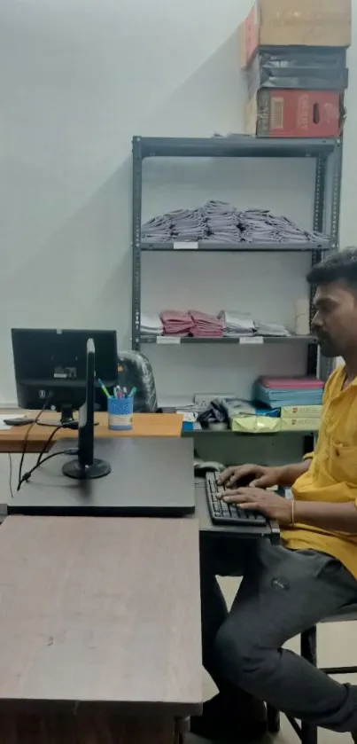 Man working in a modern office at a computer desk.