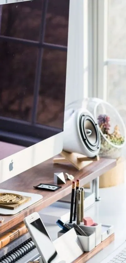 Stylish desktop with iMac and organized accessories by a window.