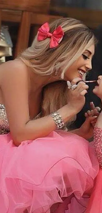 Mother and daughter in matching pink dresses, smiling happily.