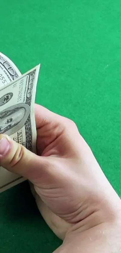 Hands counting money on a green background wallpaper.