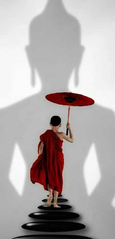 Monk holding red umbrella with shadow backdrop.