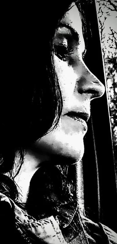 Monochrome artistic portrait of a woman's contemplative side profile.