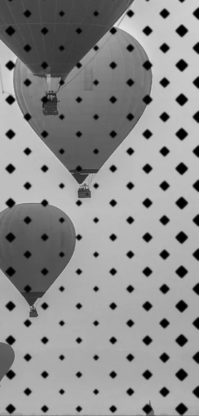 Monochrome hot air balloons overlaid with geometric pattern.