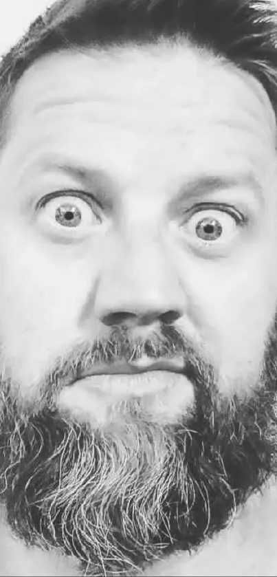 Black and white portrait of a bearded man with a surprised expression.