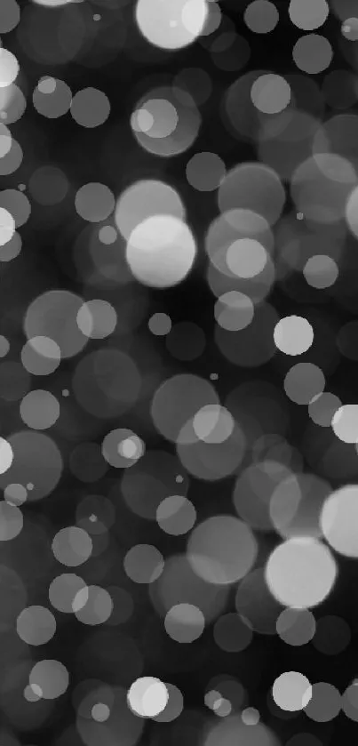 Monochrome bokeh wallpaper with elegant black and white dots.