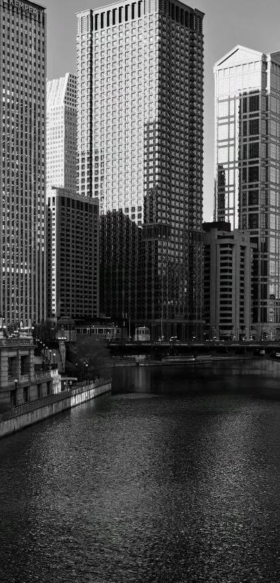 Monochrome city skyline with river reflection.