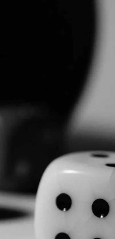 Black and white dice on a minimalist gray background.