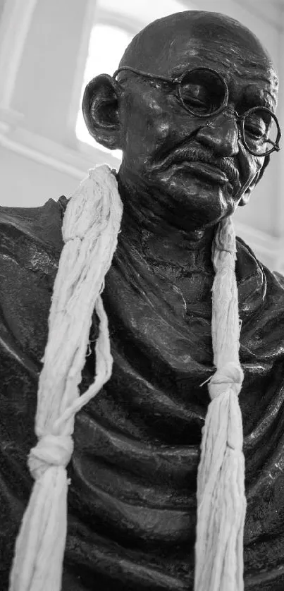 Black and white Gandhi statue in an indoor setting.