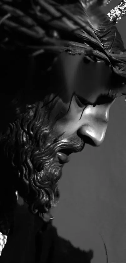 Monochrome image of Jesus sculpture on a phone wallpaper.