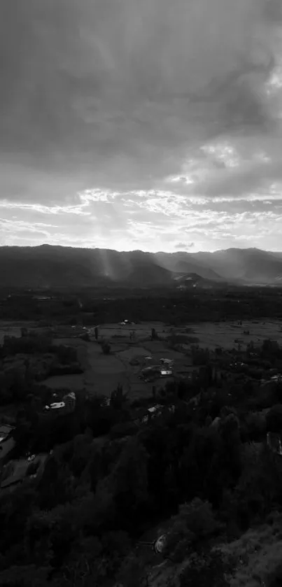 Monochrome landscape with mountains and dramatic skies, creating a serene ambiance.