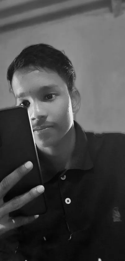 Black and white image of a person holding a smartphone.