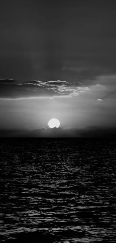 Black and white sunset over a calm ocean.