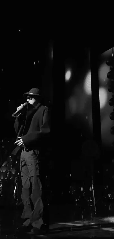 Monochrome silhouette of a performer under stage lights.