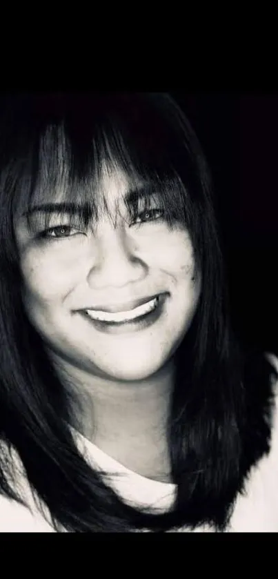 Monochrome portrait of a smiling woman in black and white.