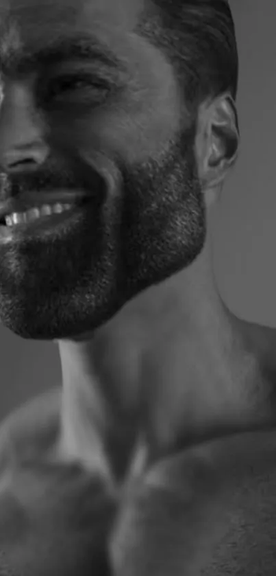 Monochrome portrait of a smiling bearded man.