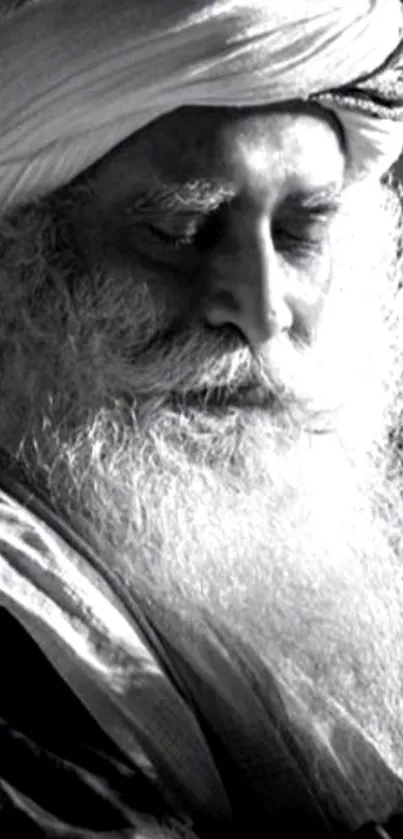 Monochrome portrait of a contemplative elderly man with a white beard.