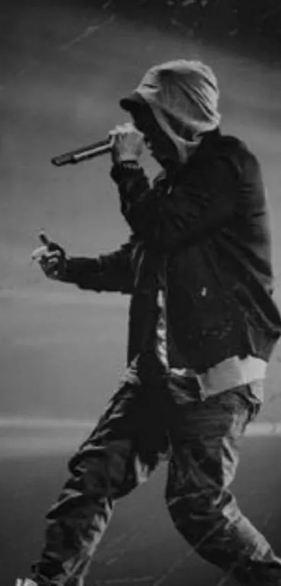 Monochrome silhouette of a rapper performing on stage with a microphone.