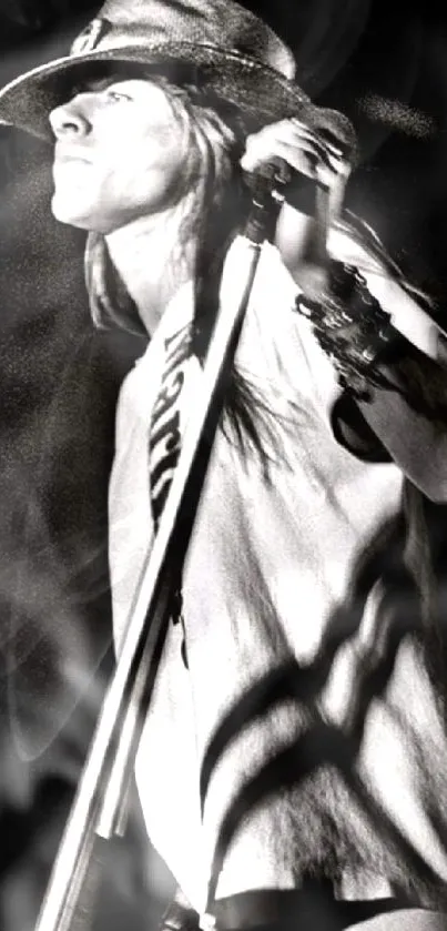 Monochrome image of rockstar performing with mic stand.