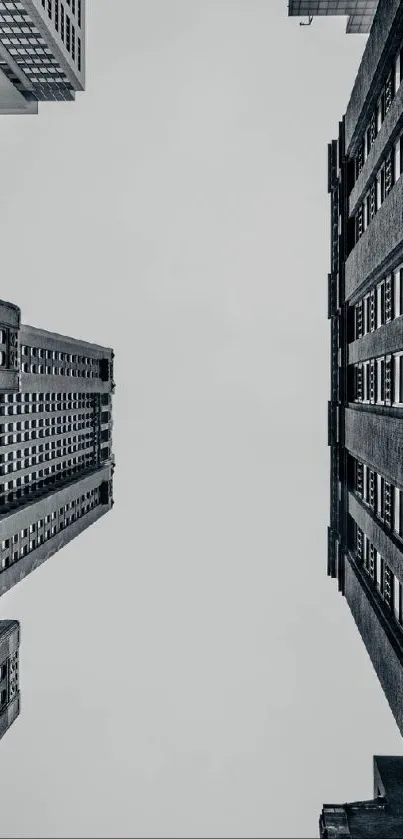 Monochrome city buildings viewed from below.