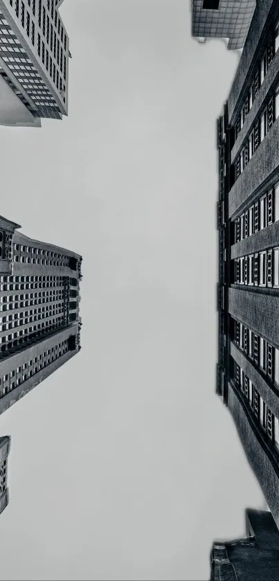 Monochrome view of towering city buildings in an urban skyline, showcasing dramatic architecture.