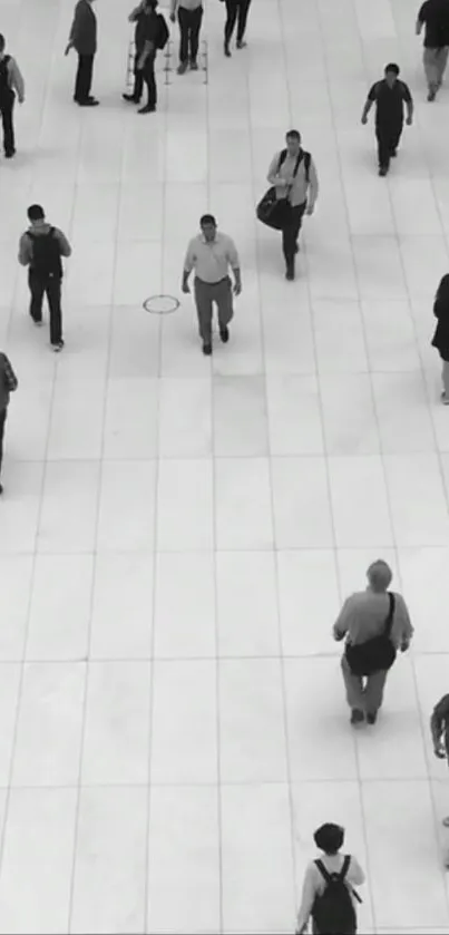 Monochrome urban scene with pedestrians on a spacious white walkway.