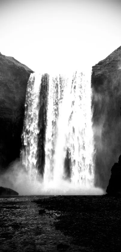 Monochrome waterfall amidst rocky cliffs, evoking serenity and natural beauty.