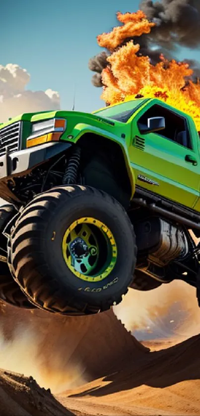 Green monster truck jumps through fiery flames in a thrilling desert scene.