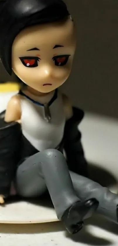 A pensive anime figure with dark hair and red eyes.