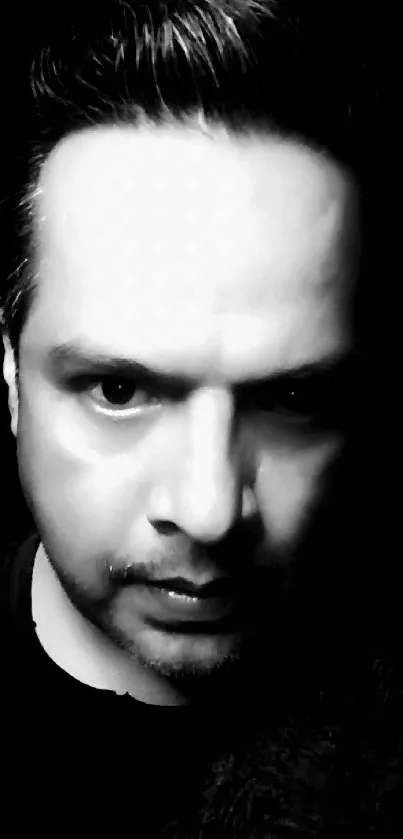 Black and white intense male portrait with a moody background.