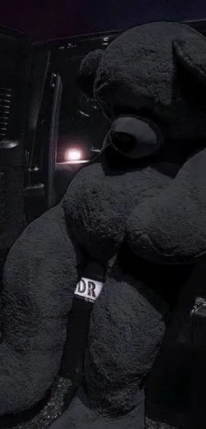 Giant black teddy bear in dark car setting.