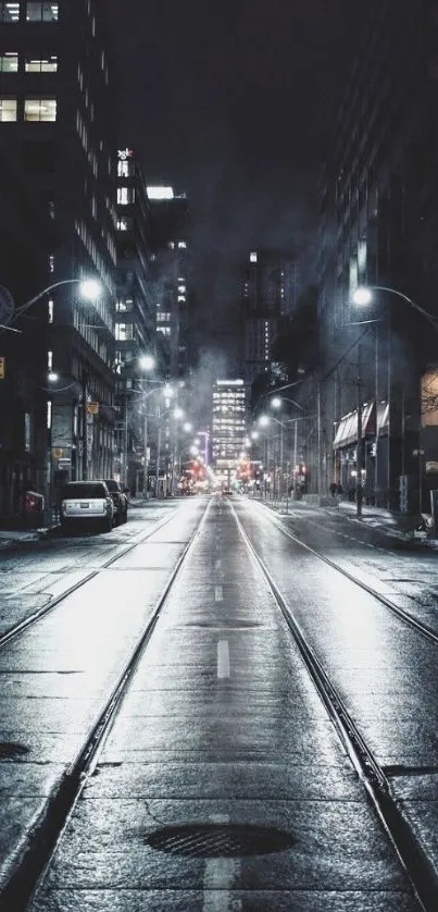 Moody city street at night with fog and lights creating a serene atmosphere.