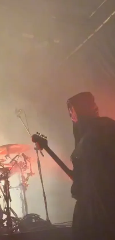 Guitarist on stage in a moody, atmospheric concert setting.